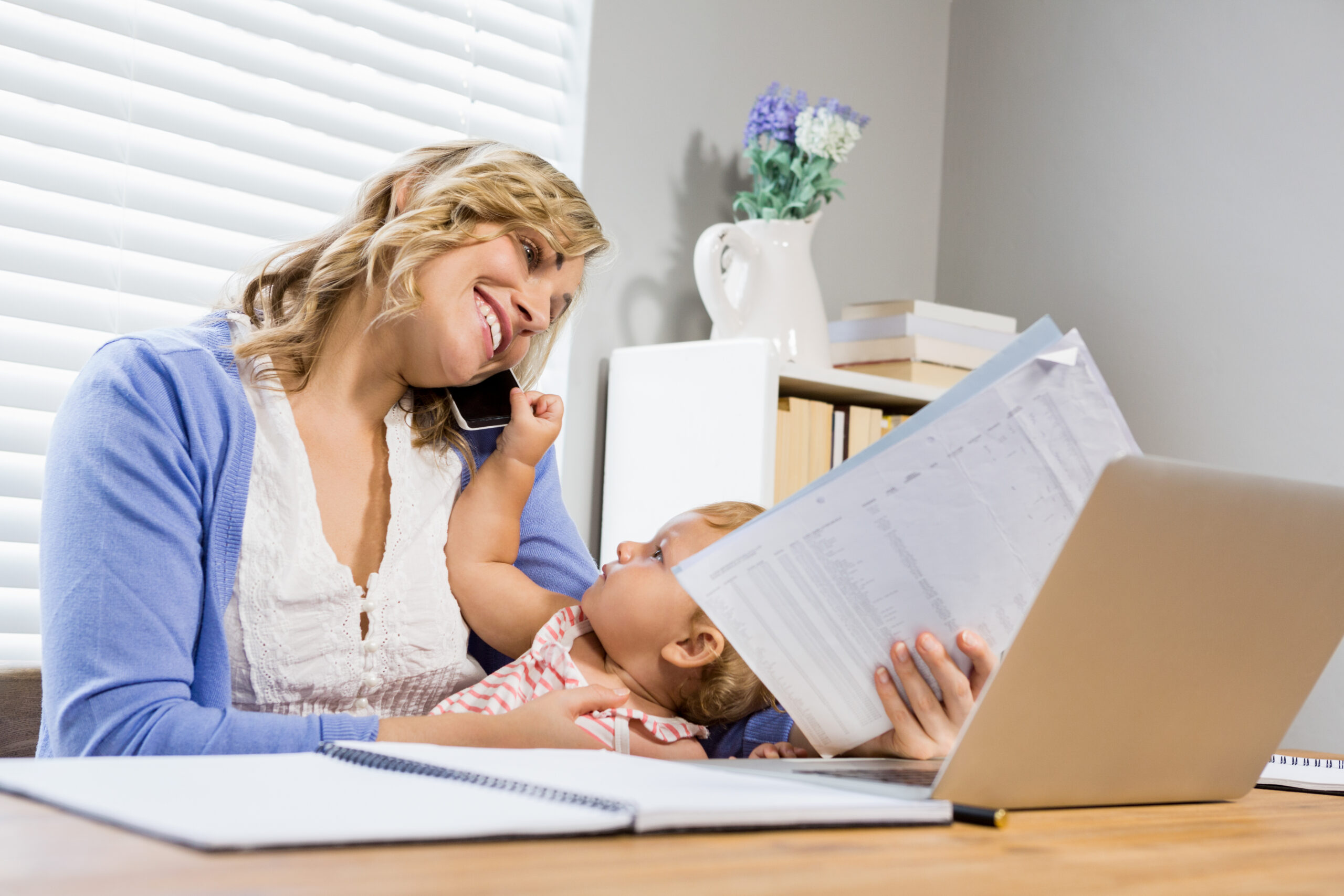 Mother working and keeping eye on her baby simultaneously 