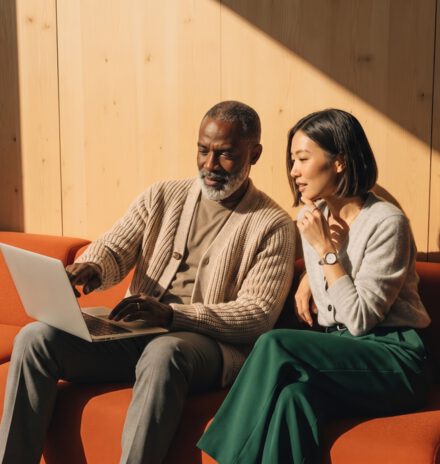 Two colleagues reviewing partner performance on a laptop