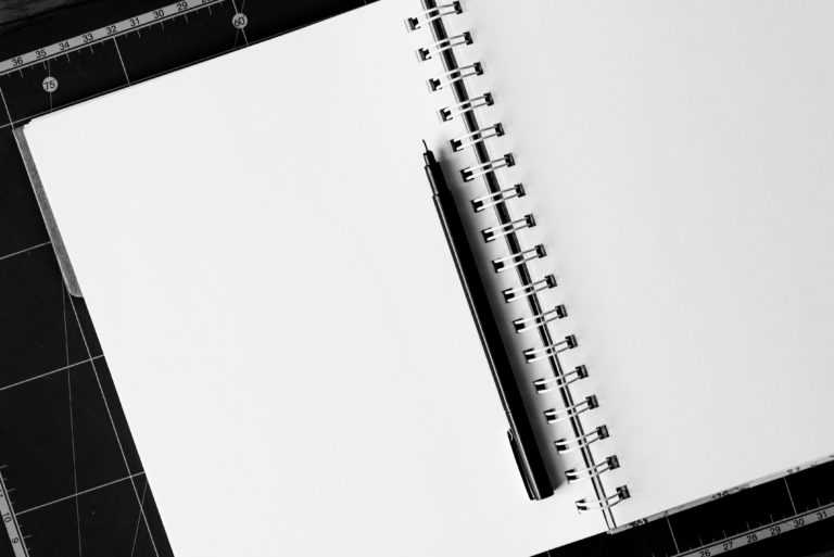 open notebook with a black pen