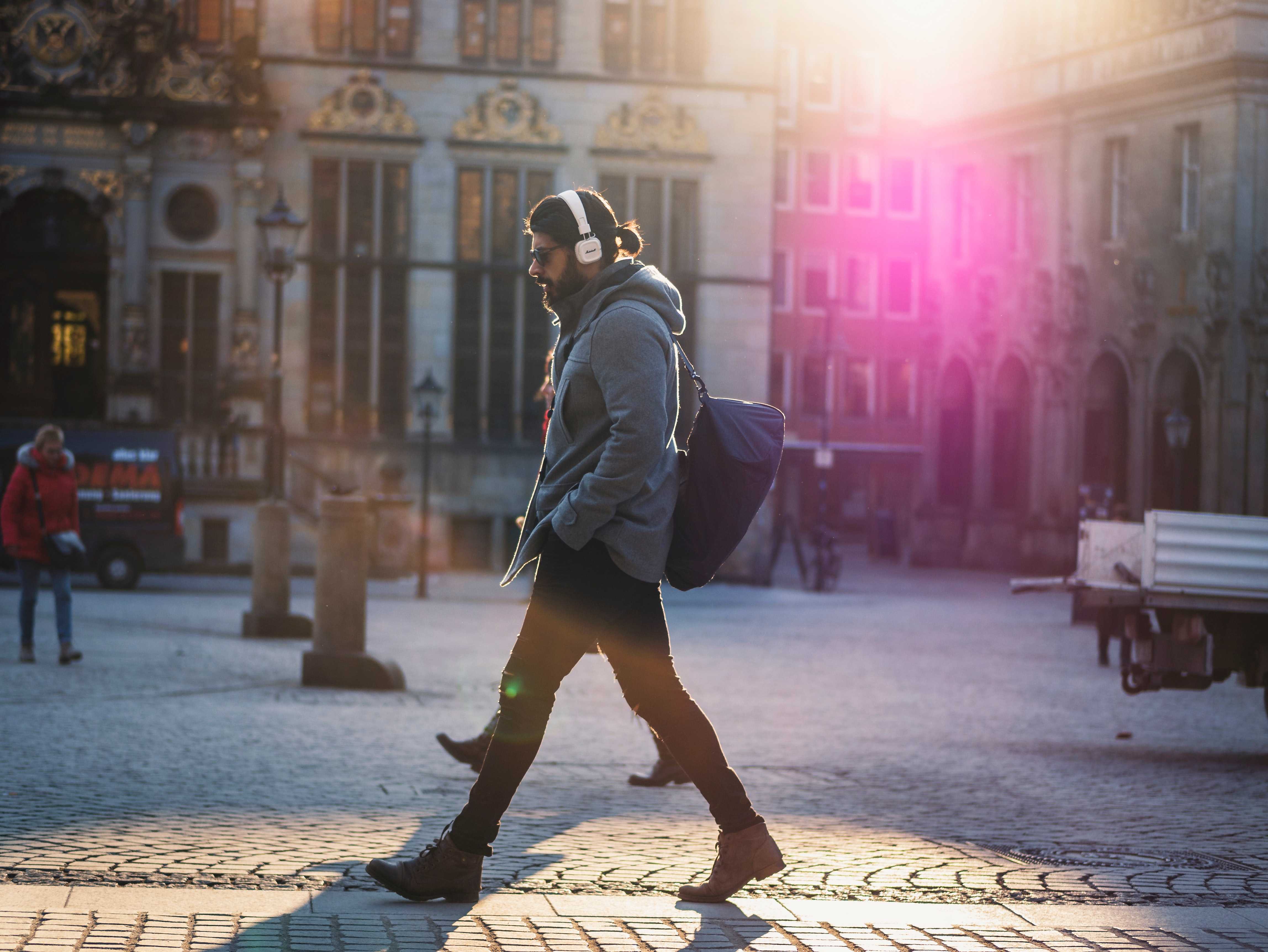 Man walking in street with headphones