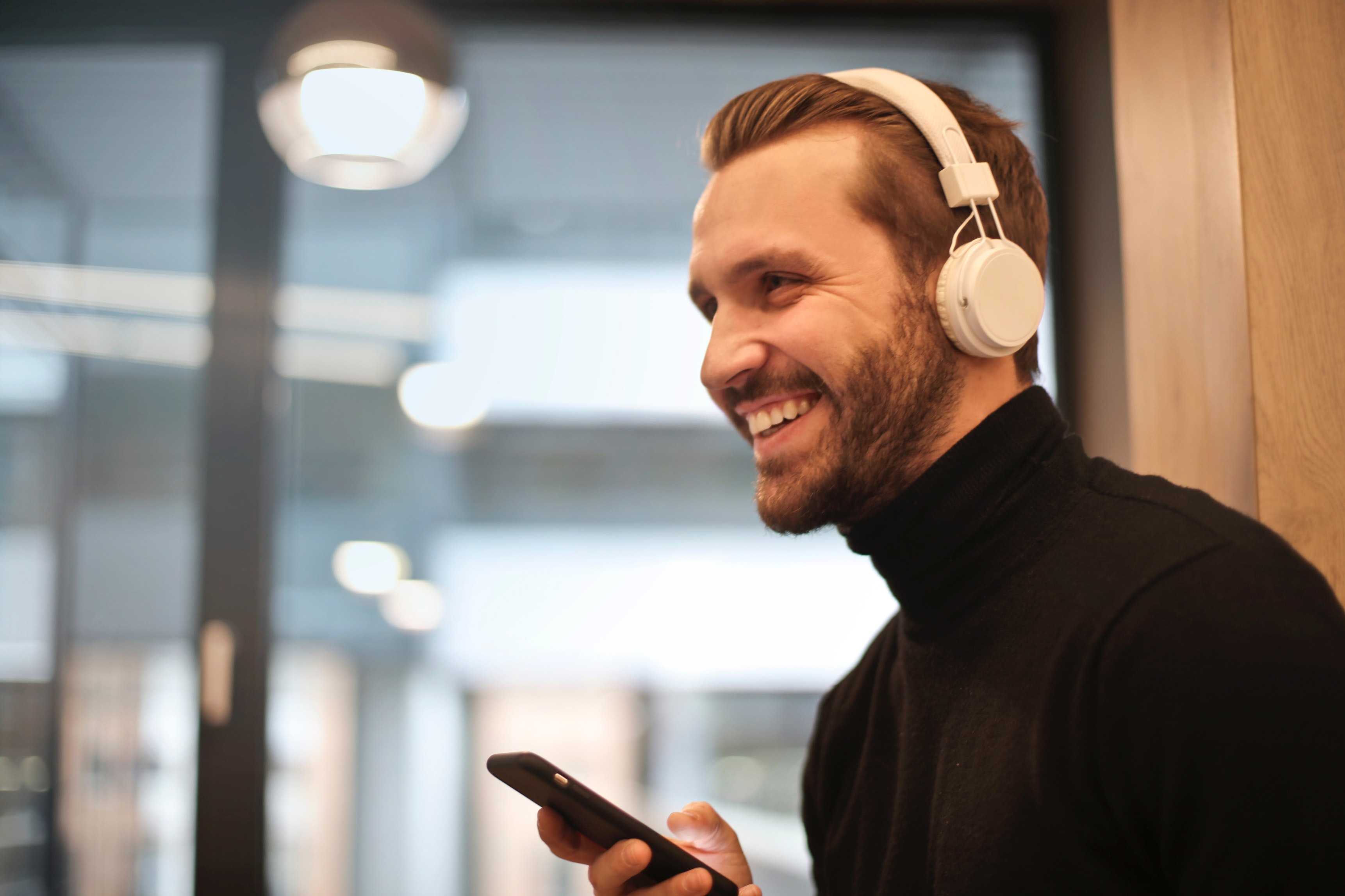 Man speaking on phone with headphones